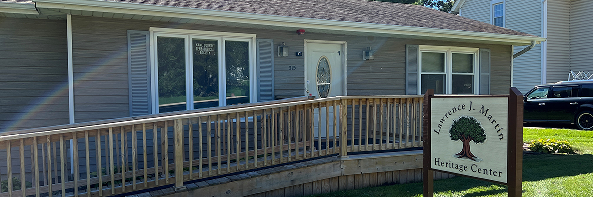 Heritage Center building with a sign out front