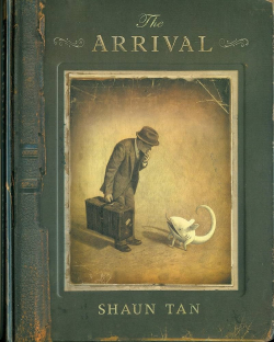The book cover shows a man in a suit carrying a suitcase looking down at a white creature that appears to be sort of an alien cat.