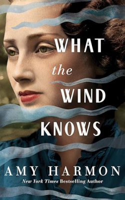 A strong wind blows across the portrait of woman with short red hair.